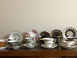 Assorted porcelain tea cups, teapots, and plates - thumbnail 1 of 13