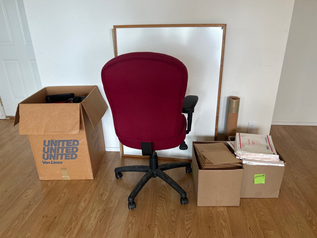 Red office chair with whiteboard and assorted office supplies - image 9 of 9