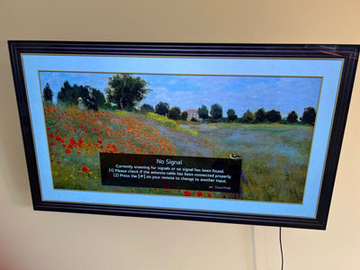 Wall-mounted LG LED TV with mounting hardware, accessories - Image 1 of 5
