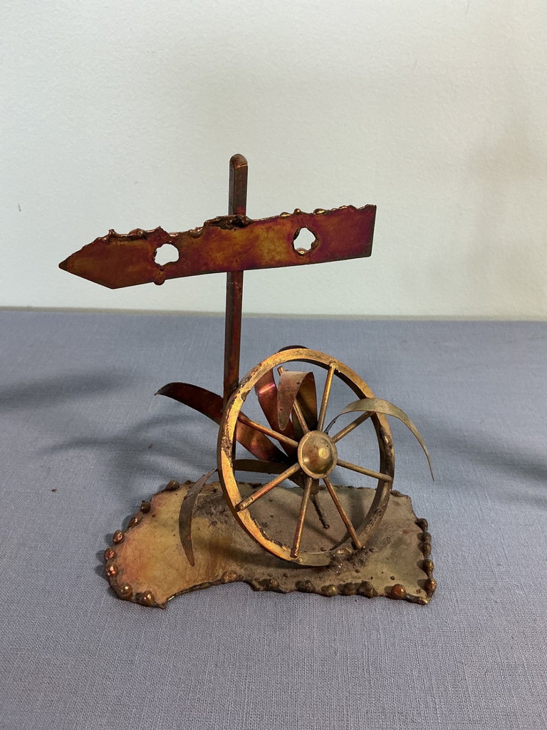 Two metal sculptures: signpost wheel and sailboat - image 1 of 3