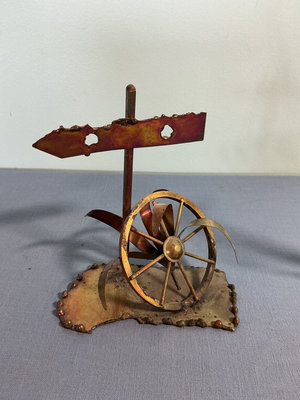 Two metal sculptures: signpost wheel and sailboat - Image 1 of 3