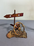 Two metal sculptures: signpost wheel and sailboat - thumbnail 1 of 3