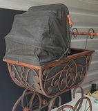 Antique wrought-iron baby carriage with decorative scrollwork - thumbnail 3 of 8