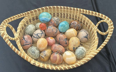 Hand woven basket from South Carolina filled with hand painted stone eggs - Image 1 of 3
