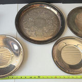 Assorted silver plate serving trays and bowls with a patterned woven rug - thumbnail 5 of 8