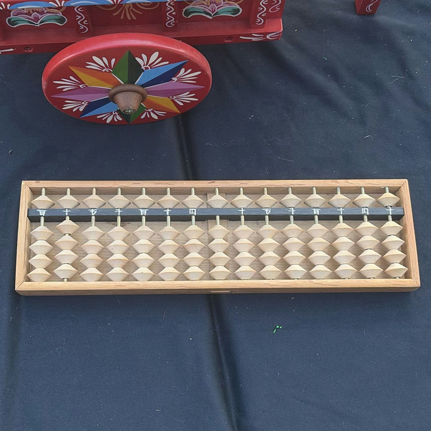 Assorted vintage decorative items: painted wooden wagon, abacus, bottle, dish, and crank - image 6 of 7