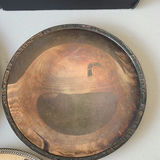 Assorted silver plate serving trays and bowls with a patterned woven rug - thumbnail 8 of 8