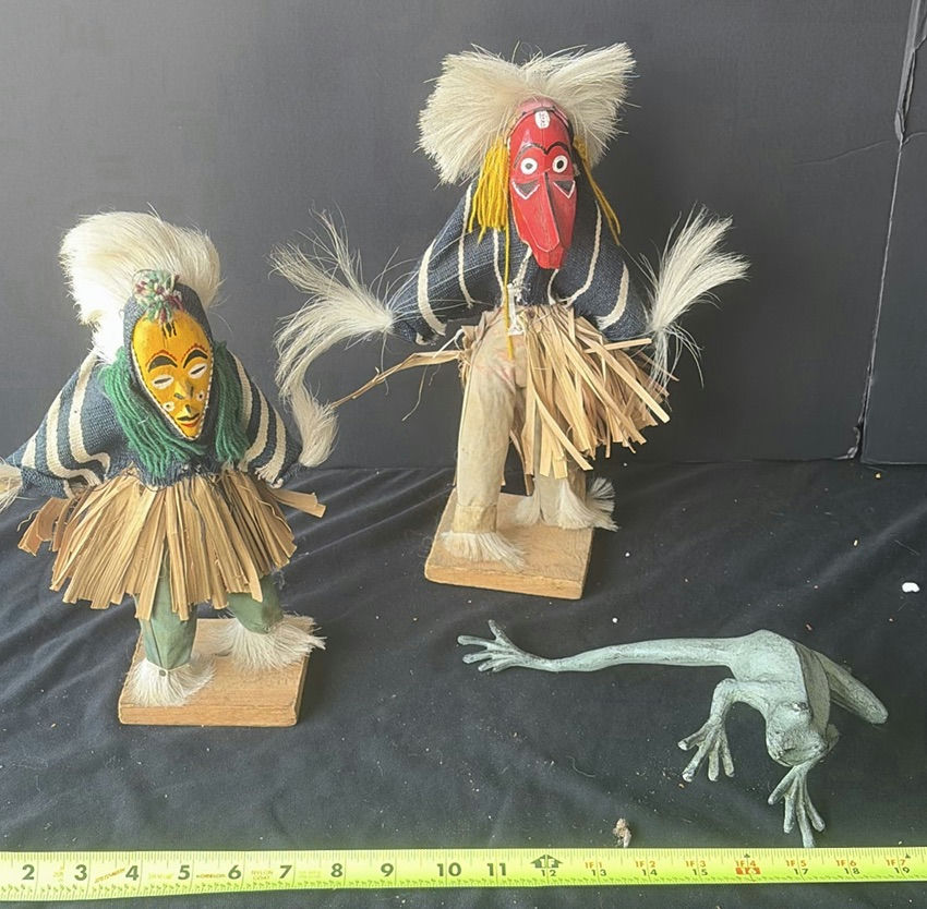 Two straw-skirted masked figures with a green frog sculpture - image 1 of 4