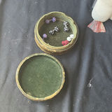 Assorted decorative items including penguin figurines, an ornate tin, a jewelry box with knotted bracelets, a glass sculpture, and round coasters - thumbnail 3 of 8