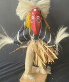 Two straw-skirted masked figures with a green frog sculpture - thumbnail 3 of 4