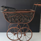 Antique wrought-iron baby carriage with decorative scrollwork - thumbnail 2 of 8