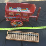 Assorted vintage decorative items: painted wooden wagon, abacus, bottle, dish, and crank - thumbnail 7 of 7