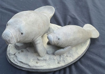 Two Manatee Sculptures on an Oval Base - Image 1 of 4