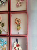 Assorted decorative brooch pins in display boxes - thumbnail 12 of 20