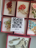 Assorted decorative brooch pins in display boxes - thumbnail 19 of 20