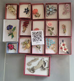 Assorted decorative brooch pins in display boxes - thumbnail 1 of 20
