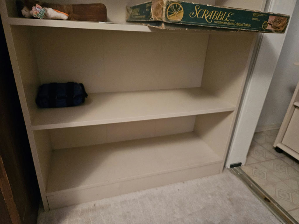 White bookshelf with books and board games - image 2 of 10