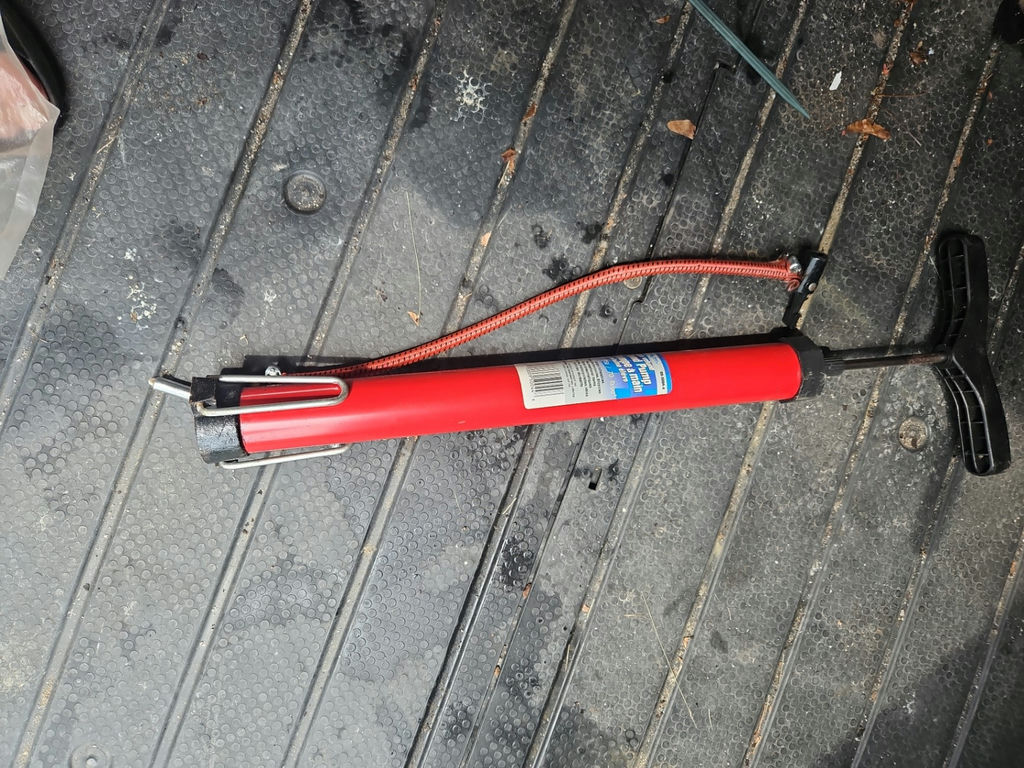 Red handheld manual air pump with hose - image 1 of 8