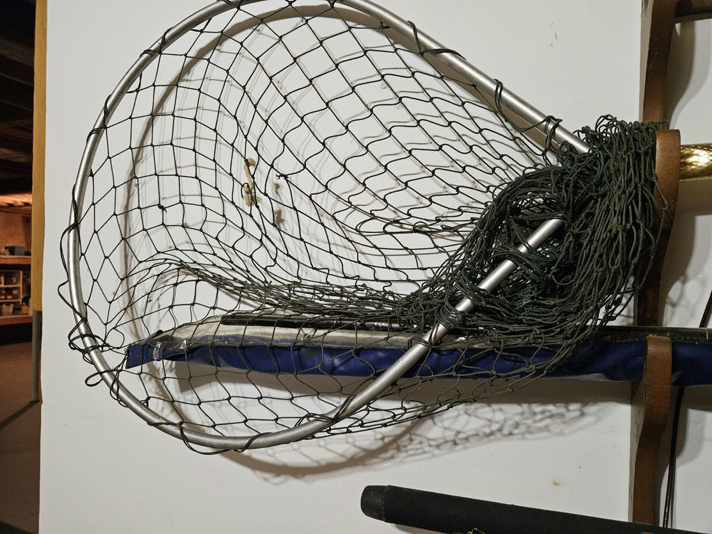 Wall-mounted fishing rod rack with reels, net, and tackle cabinet - image 2 of 5