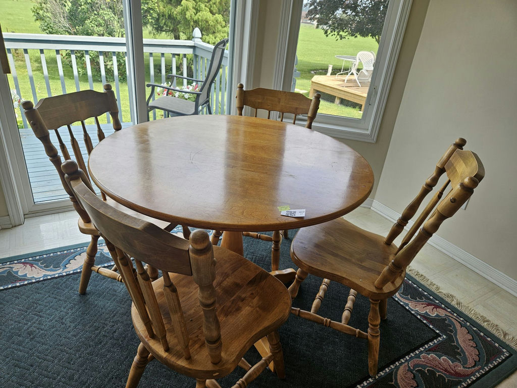 40" Round wooden dining table with four spindle-back chairs - image 1 of 7