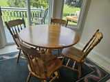 40" Round wooden dining table with four spindle-back chairs - thumbnail 1 of 7