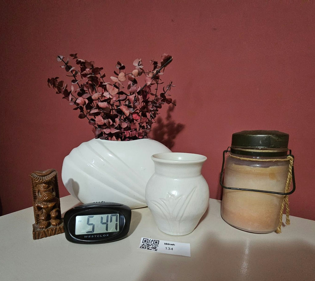 White ceramic vases, a carved tiki statue, a rope-handled jar, and a digital clock - image 1 of 7