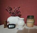 White ceramic vases, a carved tiki statue, a rope-handled jar, and a digital clock - thumbnail 1 of 7