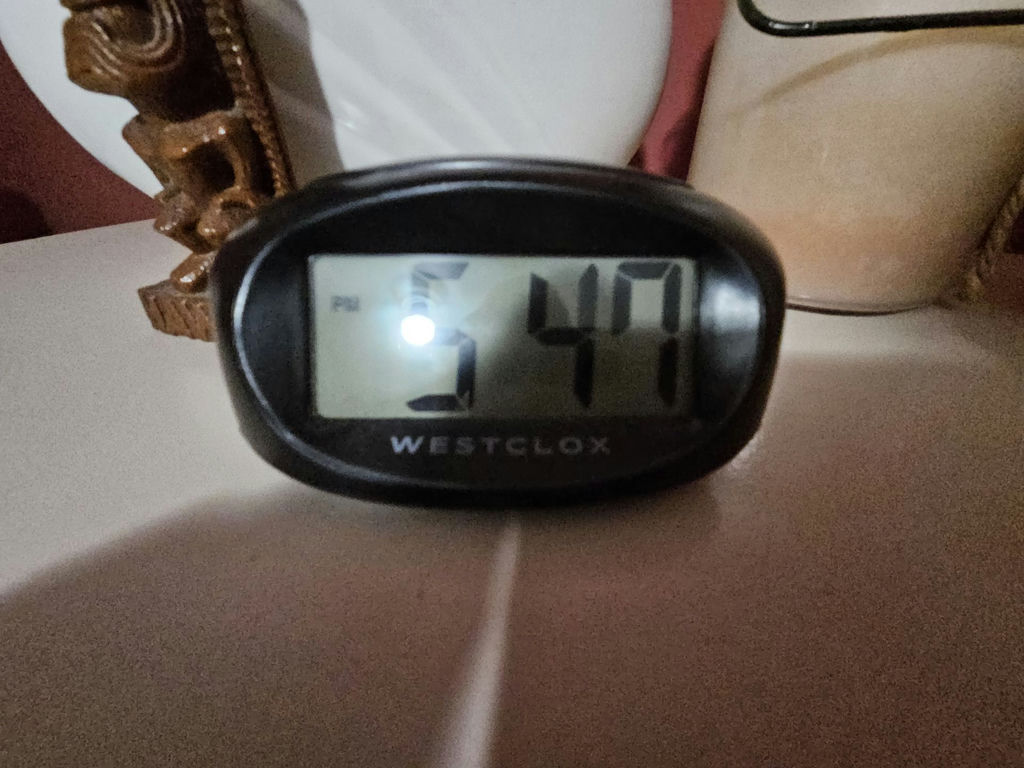 White ceramic vases, a carved tiki statue, a rope-handled jar, and a digital clock - image 3 of 7