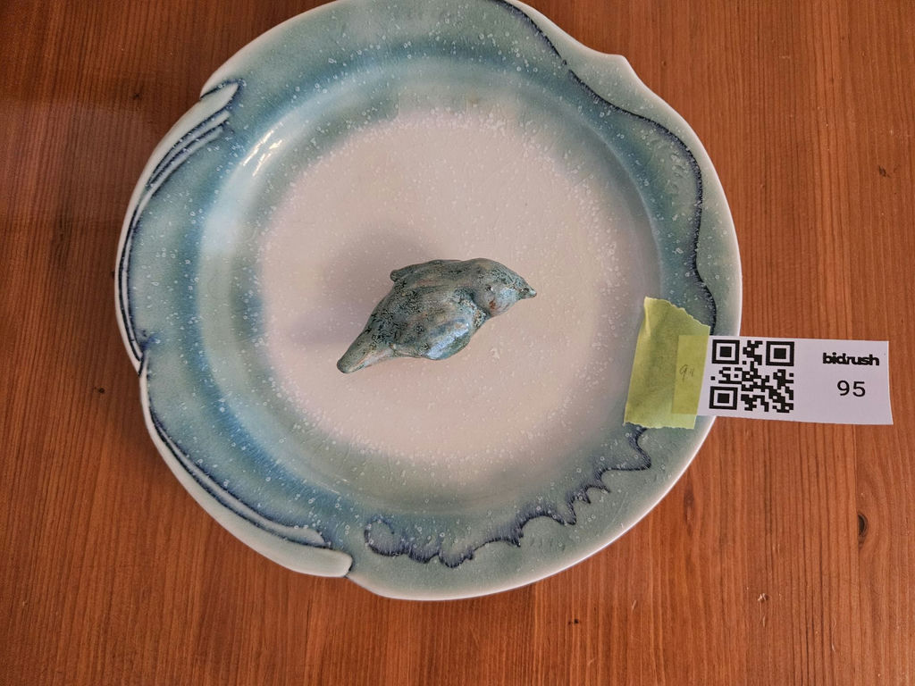 Blue-green glazed ceramic plate with small bird sculpture - image 1 of 8