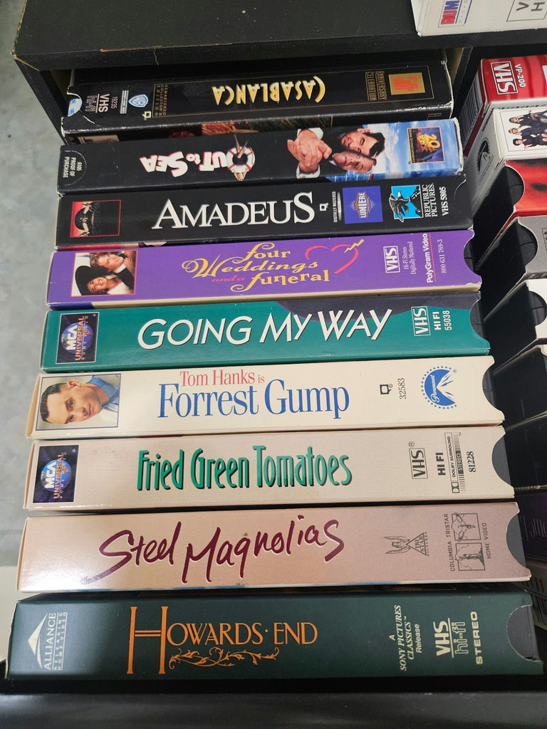 VHS tapes in a black storage cabinet with a Classical Guitar video box - image 2 of 6