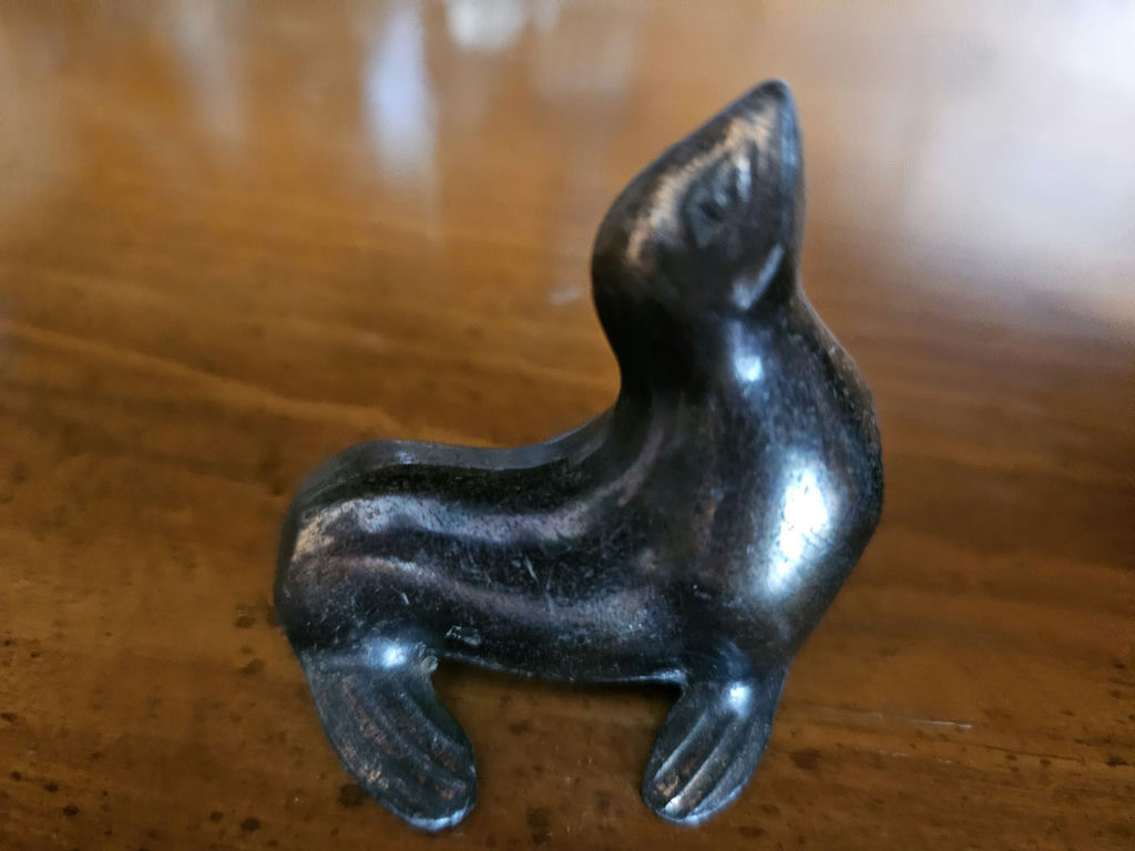 Small metal figurines: two seals, a seated female figure, and a dog - image 2 of 7