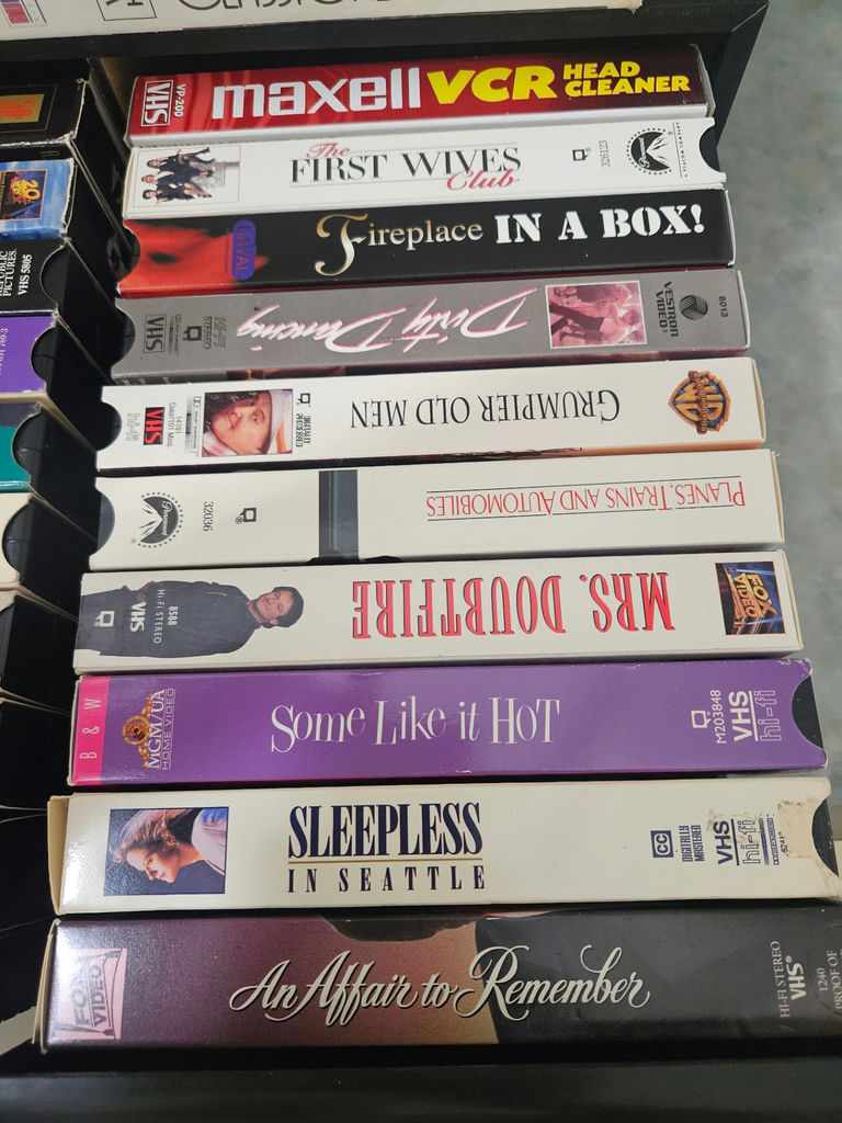 VHS tapes in a black storage cabinet with a Classical Guitar video box - image 3 of 6