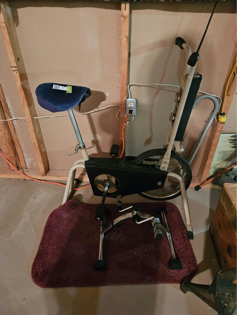 Vintage stationary exercise bike with blue seat and dual-dial console - image 1 of 4