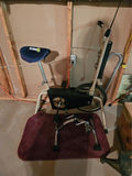 Vintage stationary exercise bike with blue seat and dual-dial console - thumbnail 1 of 4