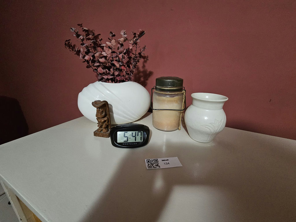 White ceramic vases, a carved tiki statue, a rope-handled jar, and a digital clock - image 2 of 7