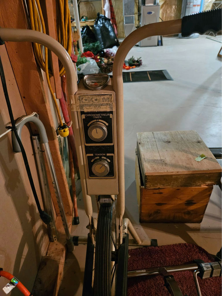 Vintage stationary exercise bike with blue seat and dual-dial console - image 4 of 4