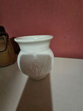 White ceramic vases, a carved tiki statue, a rope-handled jar, and a digital clock - thumbnail 5 of 7