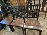 Set of three black slat-back wooden dining chairs with brown seats and a wooden table - thumbnail 3 of 5