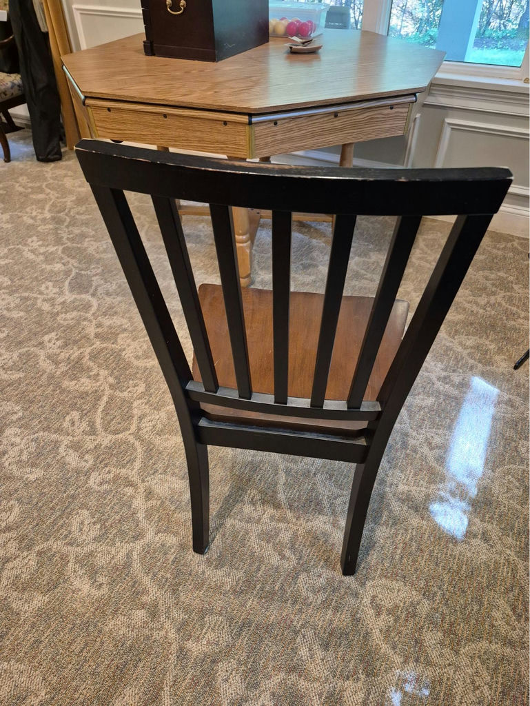 Set of three black slat-back wooden dining chairs with brown seats and a wooden table - image 2 of 5