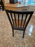 Set of three black slat-back wooden dining chairs with brown seats and a wooden table - thumbnail 2 of 5