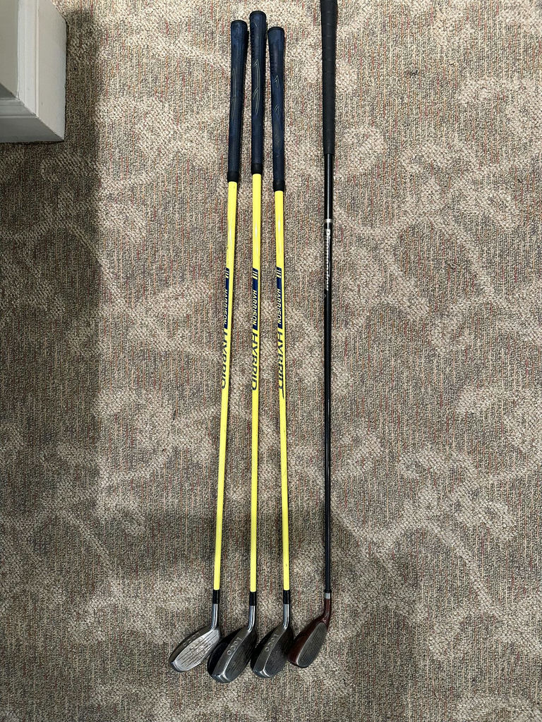 Golf clubs with yellow shafts and a black driver - image 3 of 6