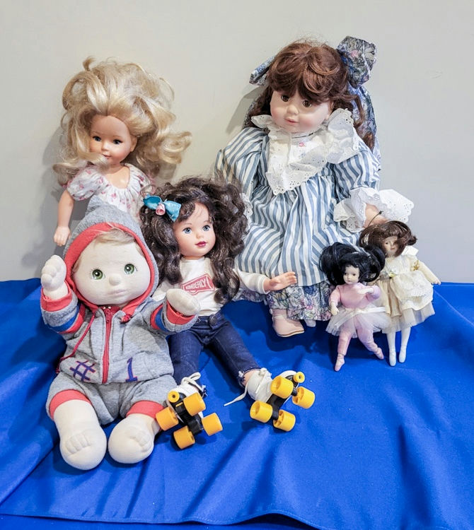 Assorted doll collection (plush, fashion, and porcelain dolls) with roller-skate accessories - image 2 of 2