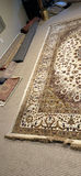 Large ornate oriental area rug with rolled rugs - thumbnail 4 of 5