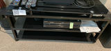 Black glass entertainment center with Blu-ray/DVD players and remotes - thumbnail 1 of 2
