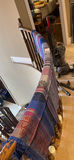 Patterned throw on stair railing with holiday trees and vacuum - thumbnail 2 of 2