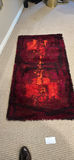 Rectangular shaggy rug with red and orange pattern - thumbnail 1 of 2