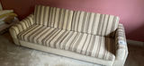 Beige striped sofa with stuffed teddy bears and framed wall art - thumbnail 1 of 7