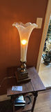 Ornate glass hurricane lamp on wooden side table - thumbnail 1 of 3