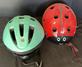 Green Schwinn bicycle helmet and red ladybug helmet - thumbnail 1 of 3