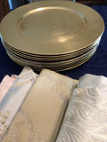 Stack of gold-toned plates with decorative patterned fabrics - thumbnail 2 of 2